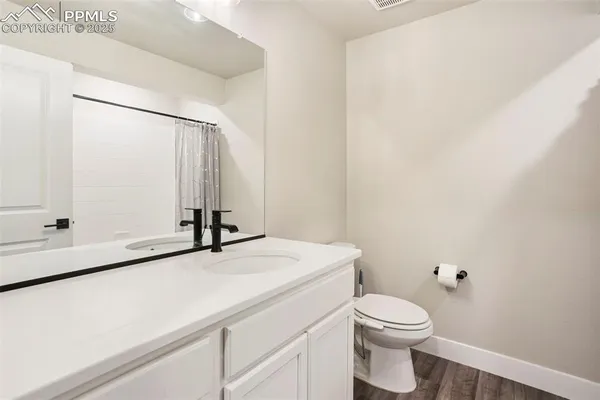 a bathroom with a sink a toilet and mirror