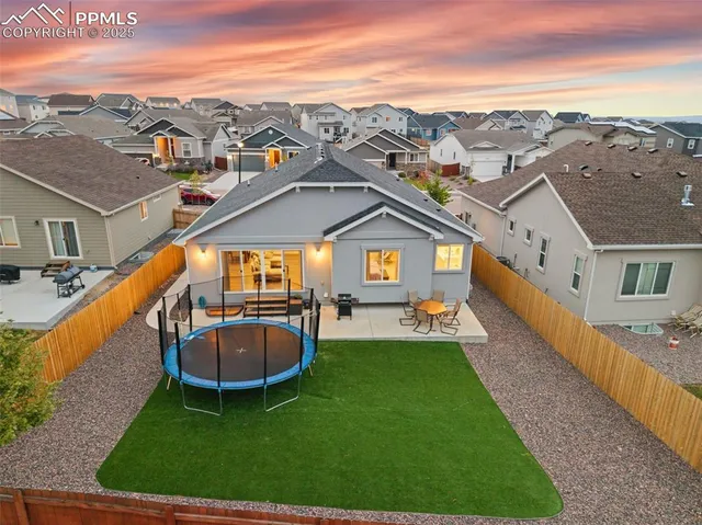an aerial view of a house with swimming pool garden and lake view