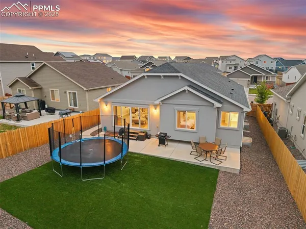 a view of a patio with a table and chairs