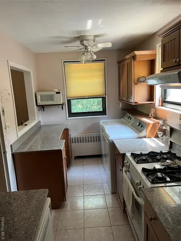 a kitchen with stainless steel appliances a stove a sink and a microwave