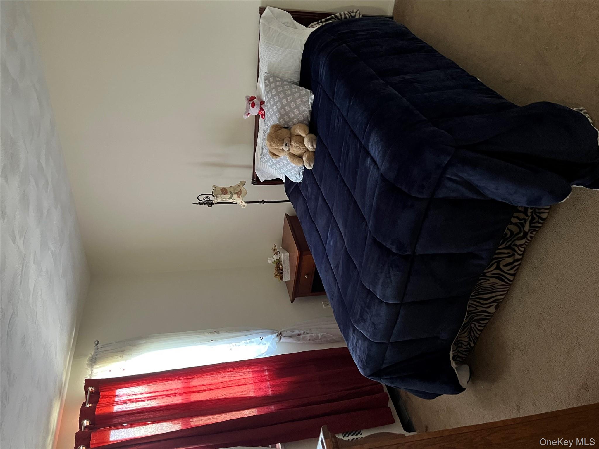 21-38 202nd Street, Unit 2 Queens, NY 11360 - Photo 8 of 11 a bedroom with a bed and window