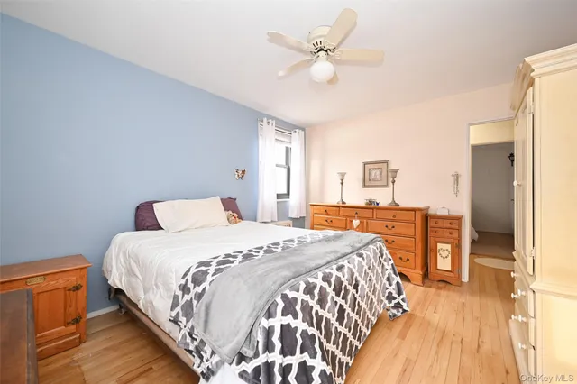 a spacious bedroom with a bed and a chandelier