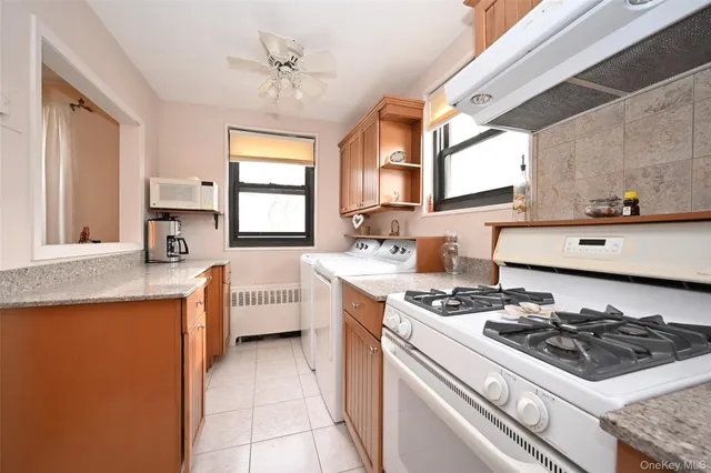 a kitchen with stainless steel appliances a stove a sink a refrigerator and cabinets