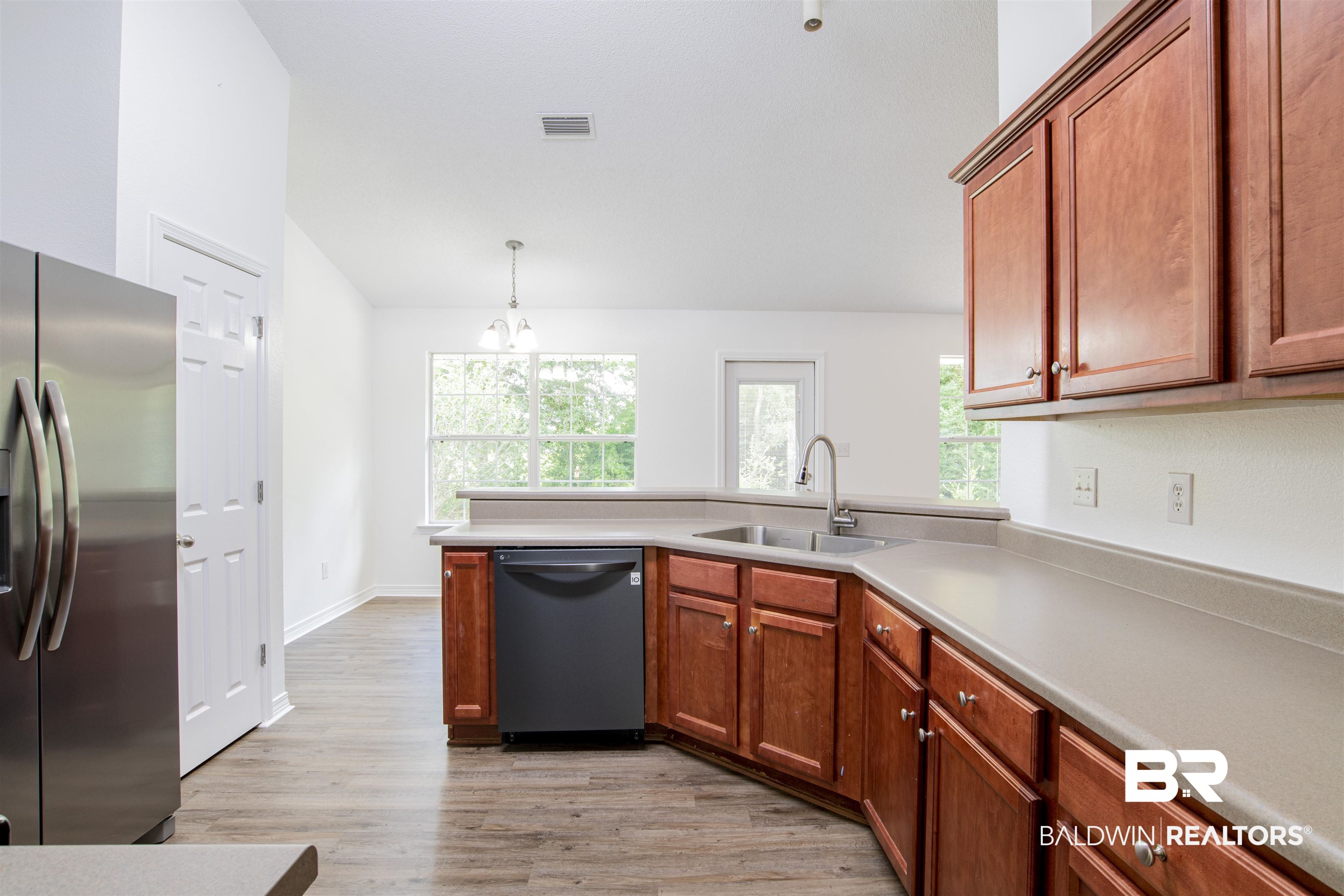 165 Pemberton Loop Fairhope, AL 36532 - Photo 16 of 25 Kitchen with light countertops, a sink, stainless steel fridge with ice dispenser, dishwashing machine, and light wood-style flooring