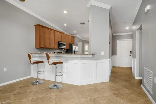 a kitchen with kitchen island cabinets and refrigerator
