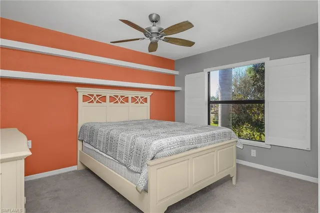 a bed sitting in a room next to a window