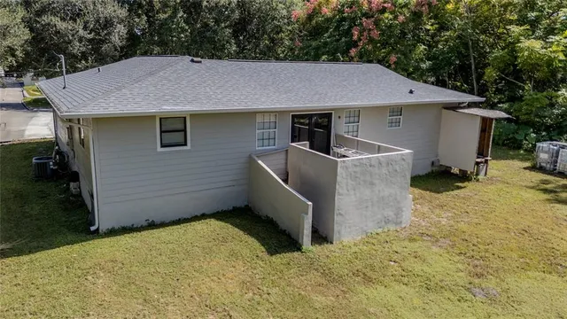 a view of a barn in the backyard of a house