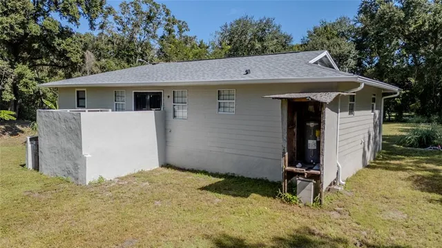 a aerial view of a house with yard and lake view