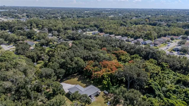 an aerial view of a houses with a yard