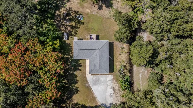 an aerial view of a house with a yard