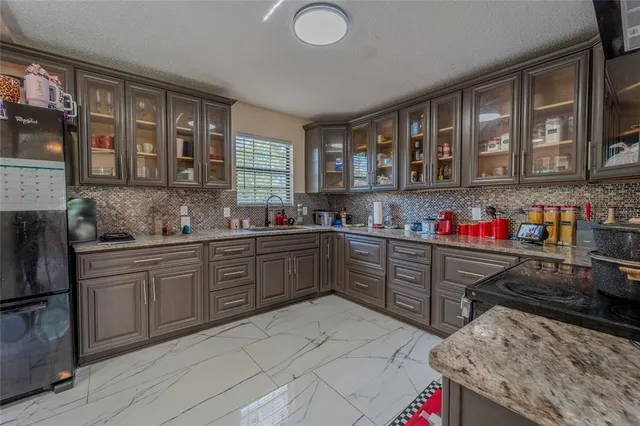 a bedroom with a bed a window and dresser