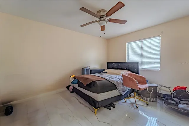 a bedroom with a bed and a window