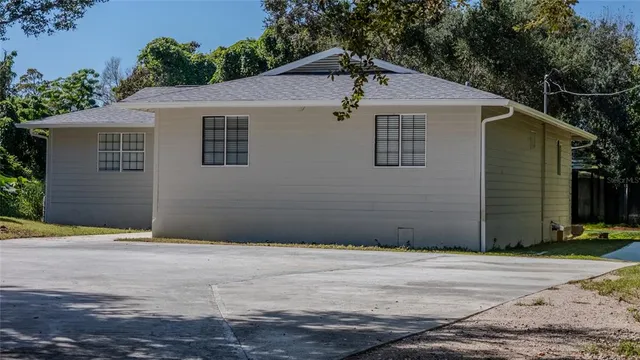 a house that has a tree in front of it