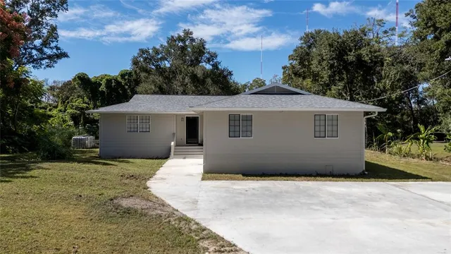 a house with green field in front of it