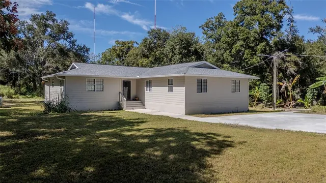 an aerial view of a house with a yard