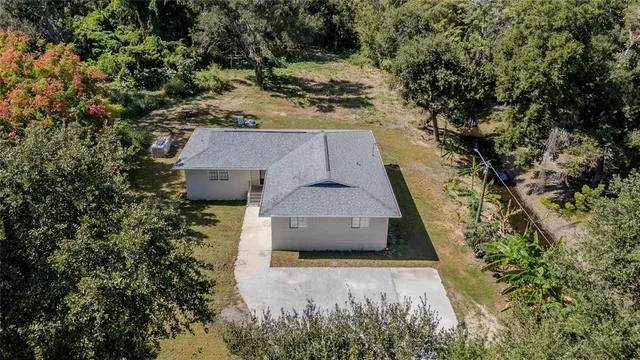 an aerial view of a house with a yard