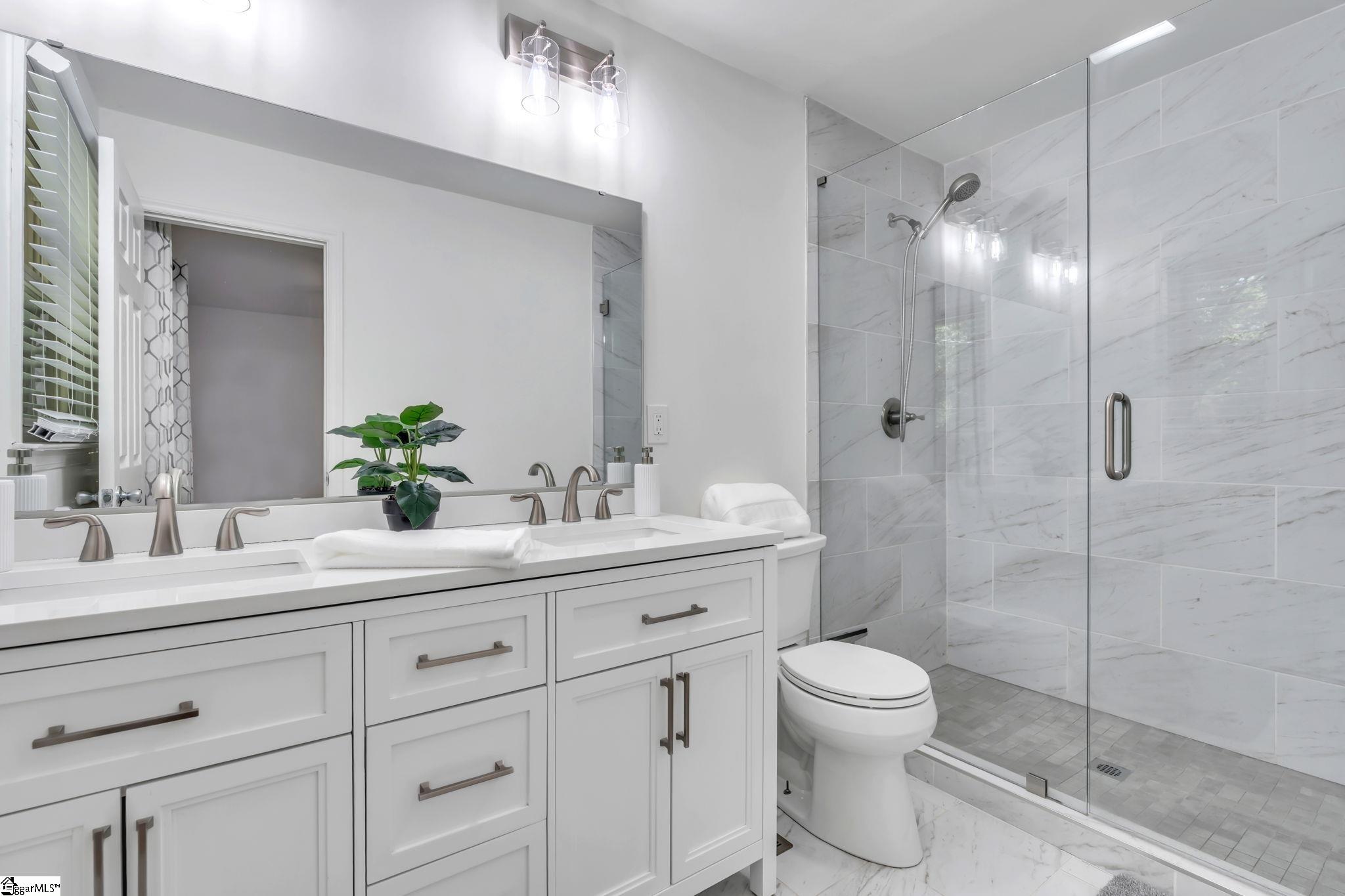 745 Canterbury Trail Fountain Inn, SC 29644 - Photo 10 of 25 Ensuite primary bathroom completely updated and upgraded. Quartz countertops, double sinks, large walk in shower and a window. Ceramic tile flooring