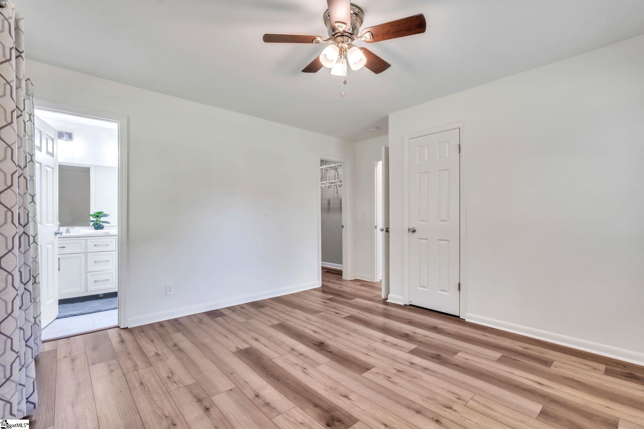 745 Canterbury Trail Fountain Inn, SC 29644 - Photo 12 of 25 This view of the Primary Bedroom shows entry to ensuite bathroom, walk in closet, as well as the additional closet.