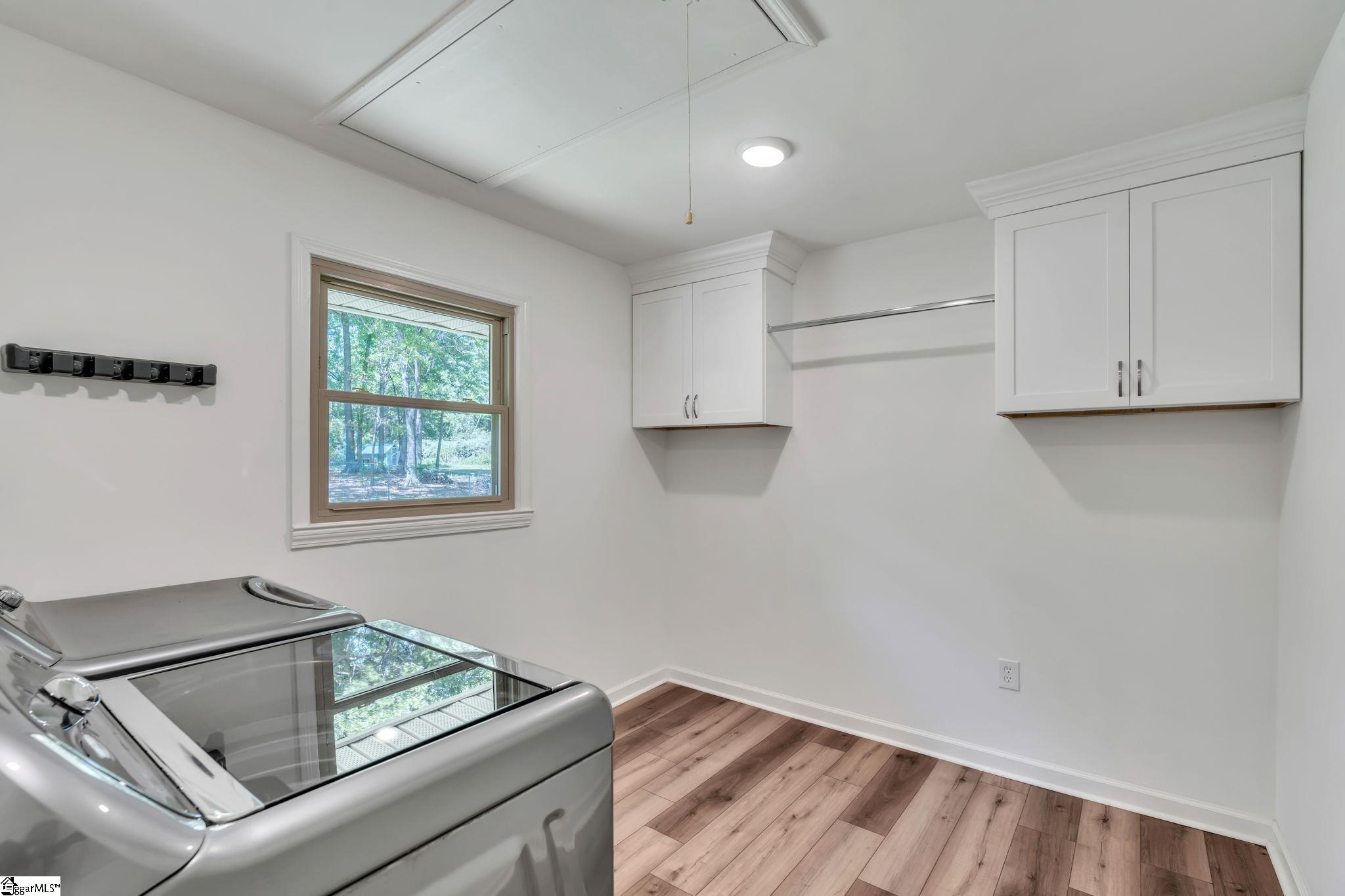 745 Canterbury Trail Fountain Inn, SC 29644 - Photo 16 of 25 Look at this great laundry room with plenty of space, cabinets, clothes hanging area, and lots of natural light.
