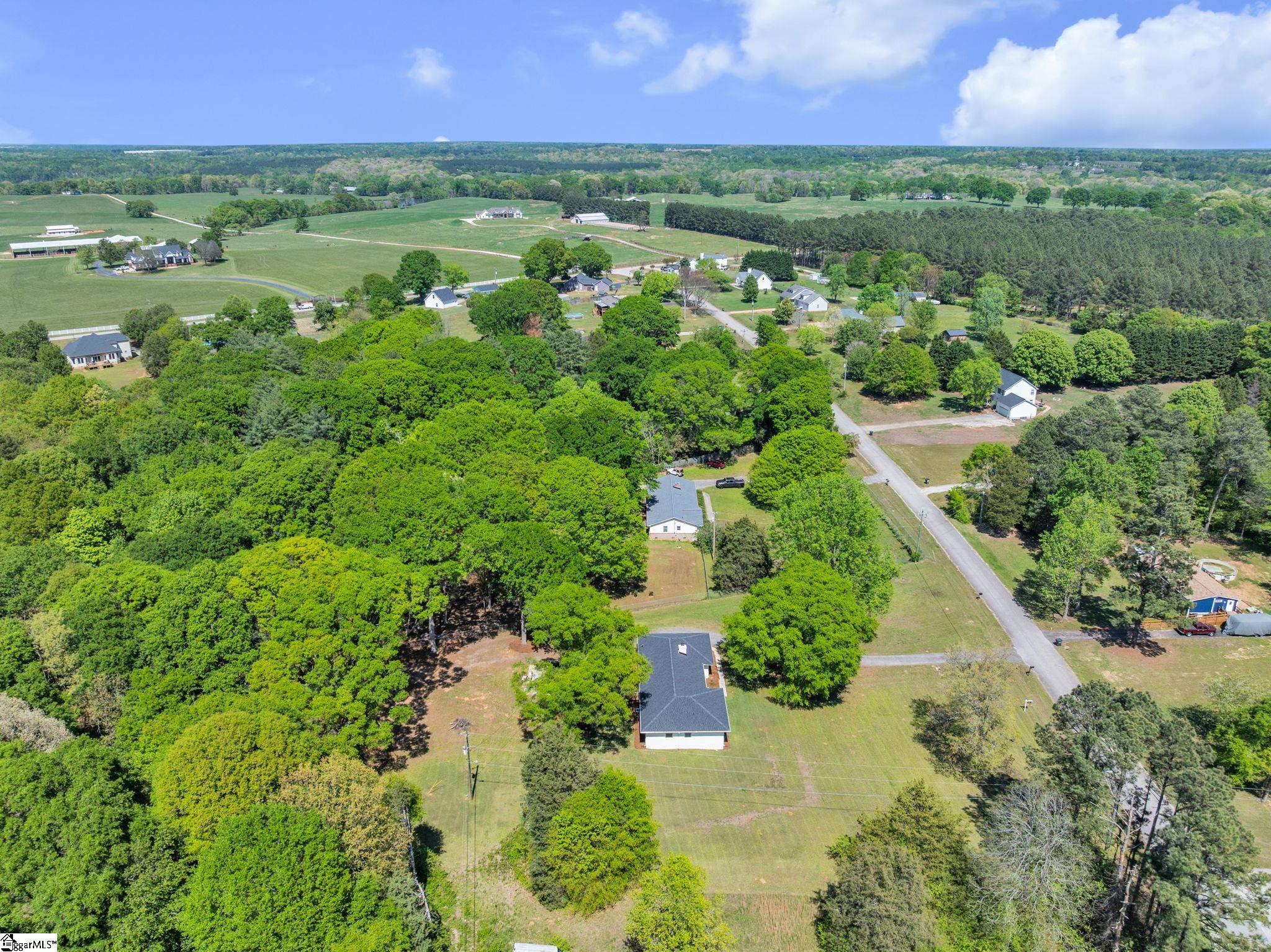 745 Canterbury Trail Fountain Inn, SC 29644 - Photo 22 of 25 Aerial view showing side of house and beautiful trees in the area.