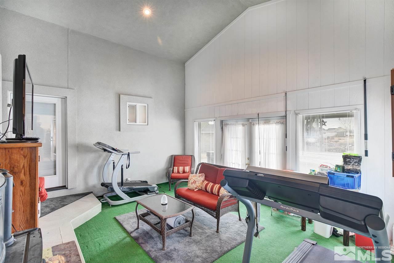 1895 Heidi Road Fallon, NV 89406 - Photo 19 of 24 a living room with furniture a rug and a floor to ceiling window