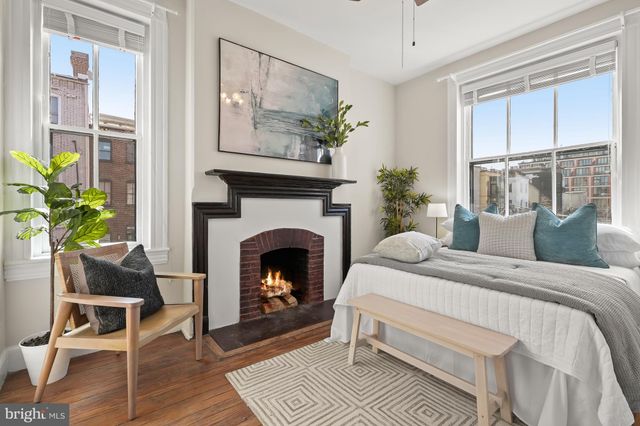 a bedroom with a bed and a fireplace