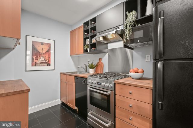 a kitchen with stainless steel appliances granite countertop a stove and a refrigerator