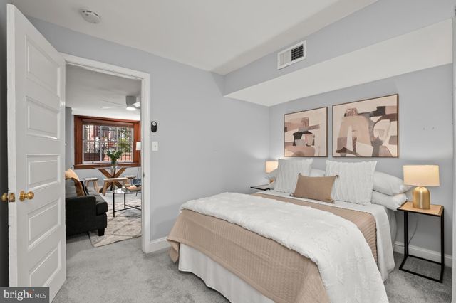 a bedroom with a bed and a painting on the wall