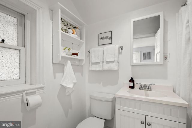 a white toilet sitting next to a bathroom sink