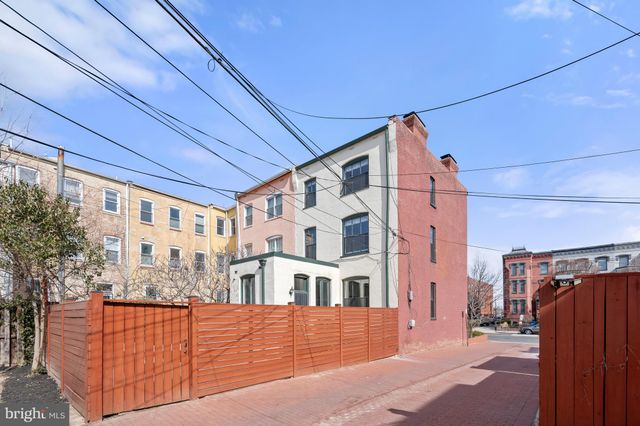 a view of a blue house with large windows