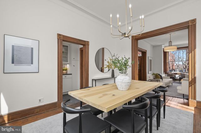 a view of a dining room with furniture and a chandelier