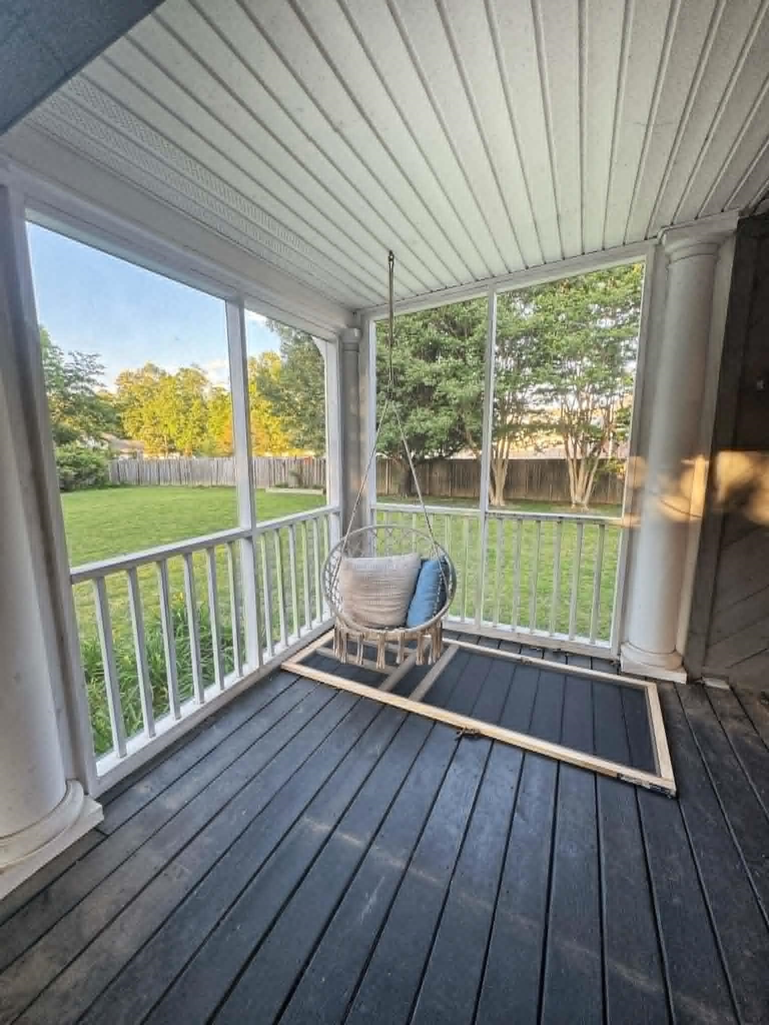 37 Crownpointe Cove Jackson, TN 38305 - Photo 35 of 39 Screened porch featuring dark wood-finish flooring, white spindle railings, and fluted columns