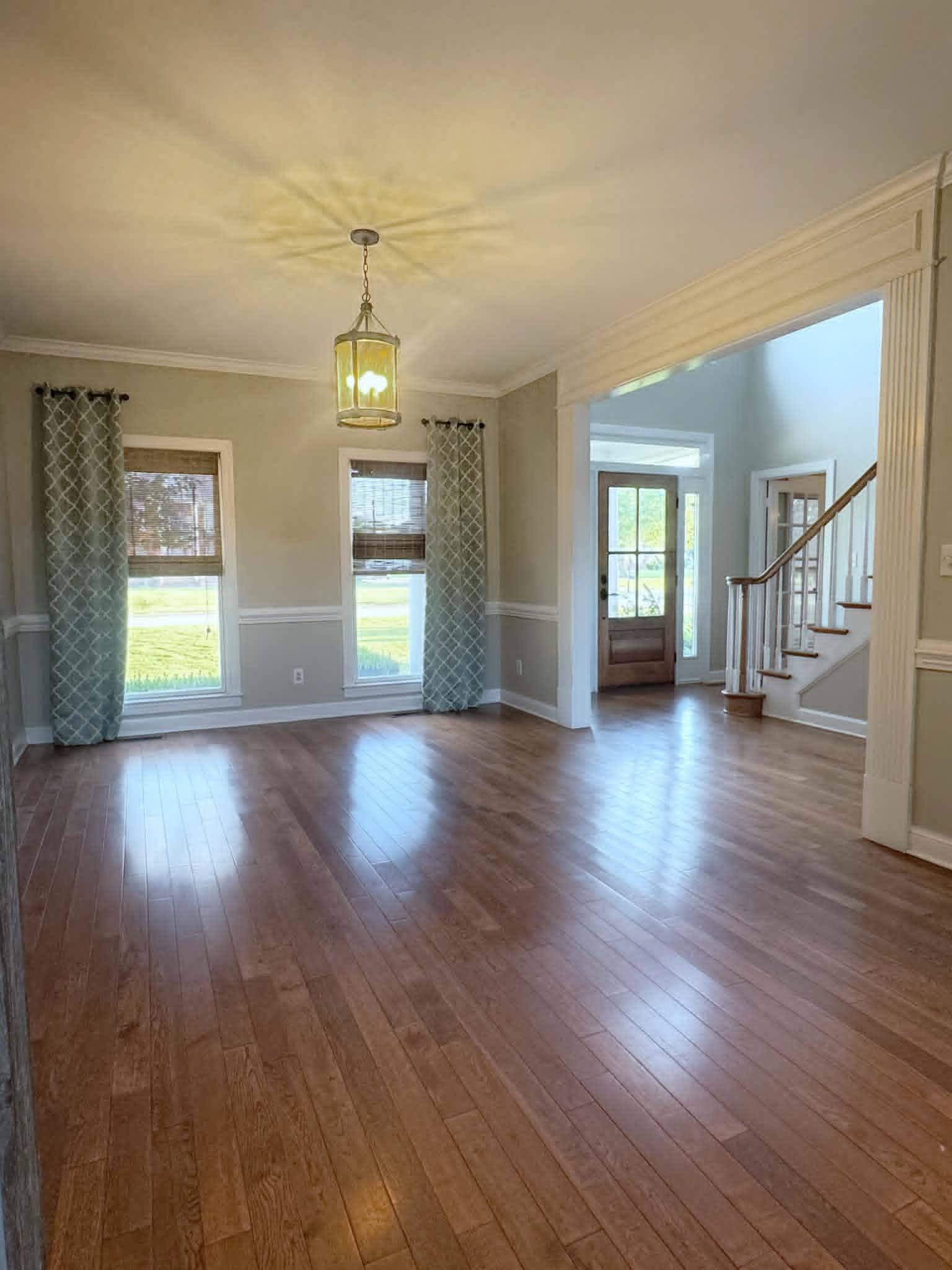 37 Crownpointe Cove Jackson, TN 38305 - Photo 6 of 39 Spacious interior room featuring wood-finish flooring, a decorative ceiling light fixture, and crown molding