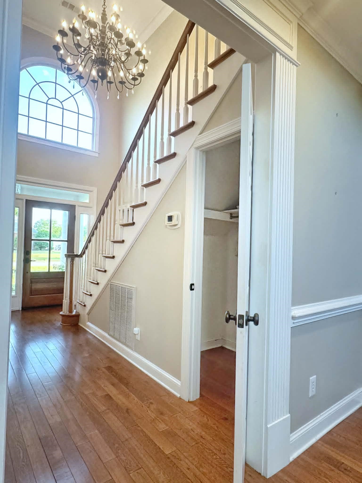 37 Crownpointe Cove Jackson, TN 38305 - Photo 7 of 39 Grand entryway featuring wood-finish flooring, a two-story ceiling, and an arched transom window