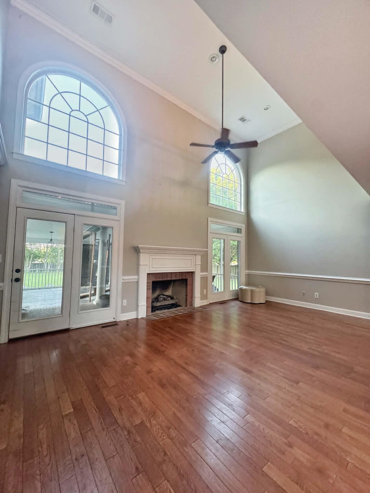 37 Crownpointe Cove Jackson, TN 38305 - Photo 9 of 39 Vaulted ceiling great room featuring wood-finish flooring and a brick-surround fireplace with white mantel