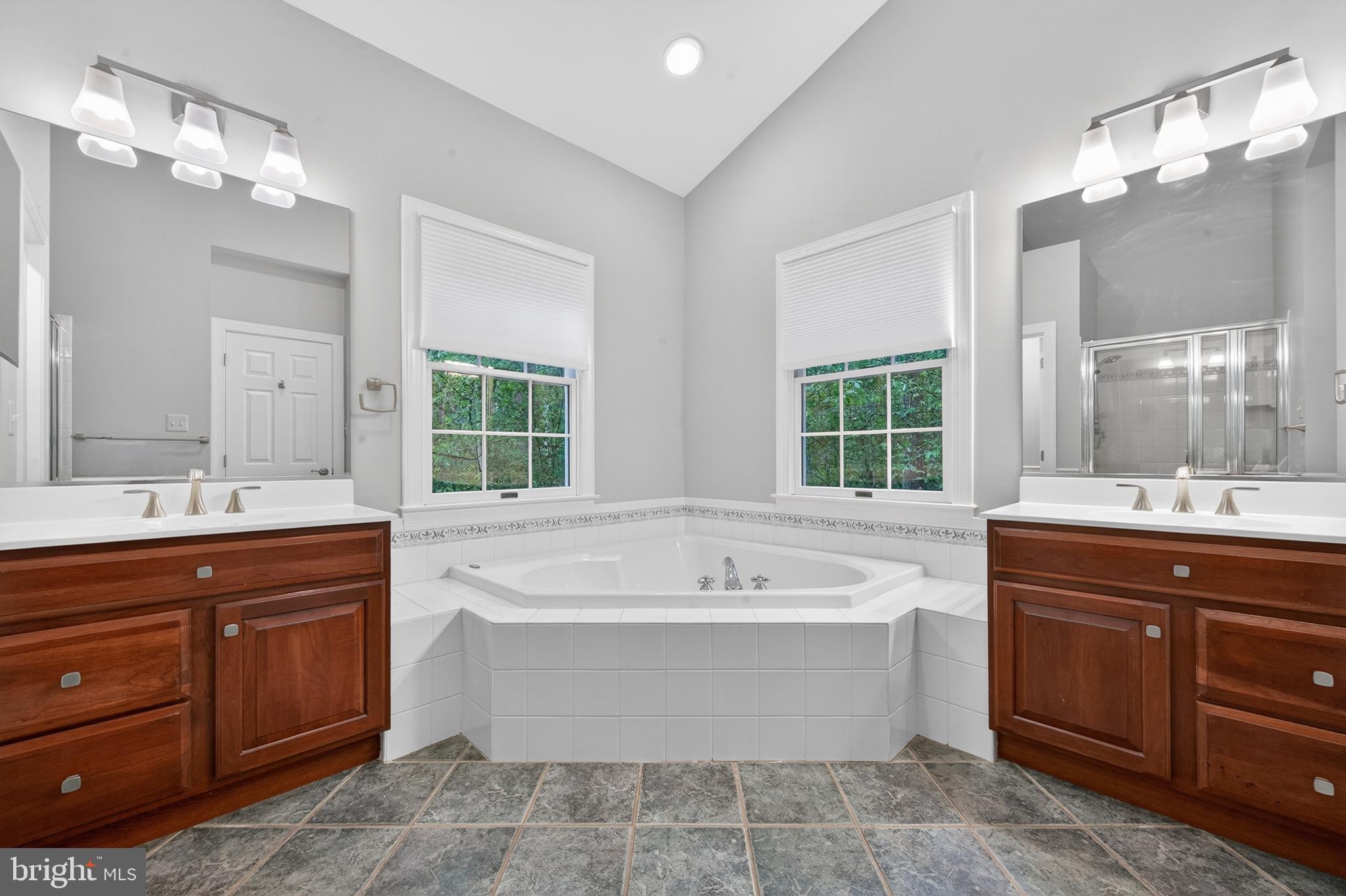 6601 Colchester Road Fairfax Station, VA 22039 - Photo 36 of 78 a spacious bathroom with a tub sink shower and mirror