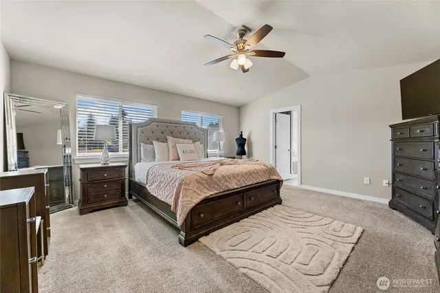 a bedroom with a large bed and a tv