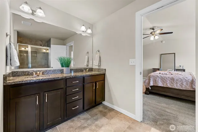 a en suite bathroom with a double vanity sink and a mirror