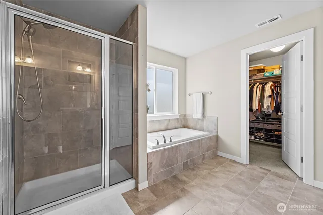 a bathroom with a tub shower and sink