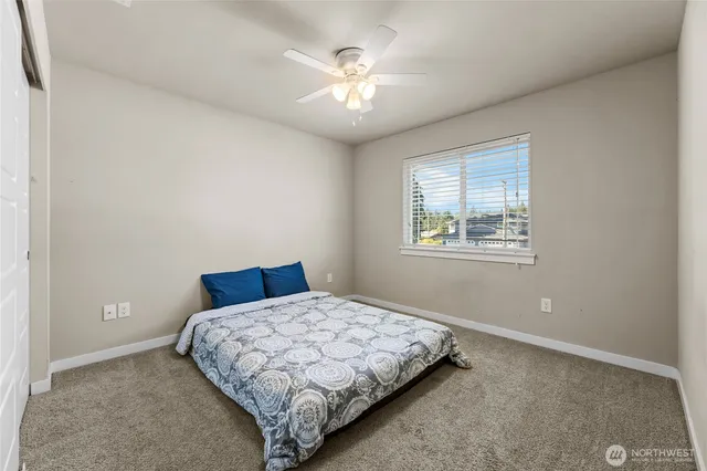 a bedroom with a bed and a window