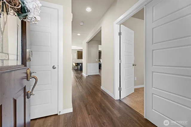 a view of a hallway with wooden floor and staircase