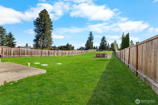 a view of yard with swimming pool and green space