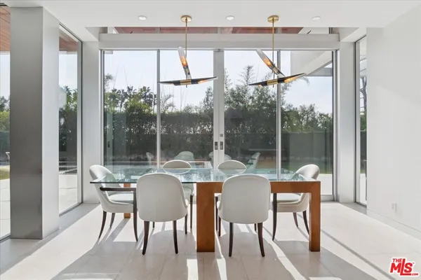 a dining room with furniture a chandelier and wooden floor