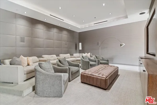 a living room with couches and a flat screen tv