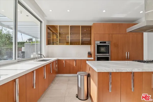a kitchen with a sink and large cabinets