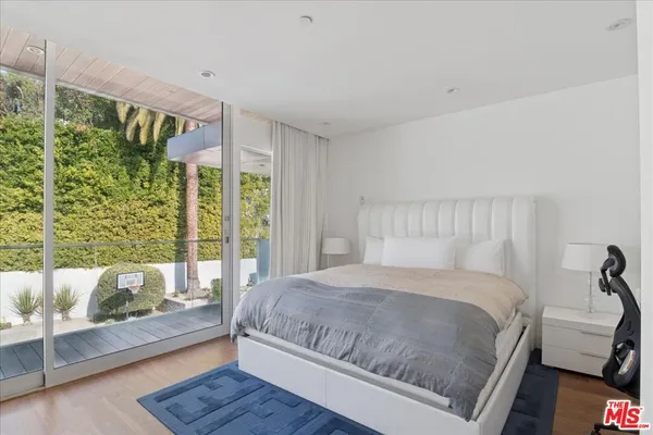 a bedroom with a large bed and a large window
