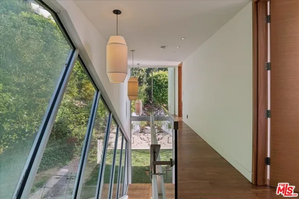 a view of a patio with couches table and chairs and potted plants