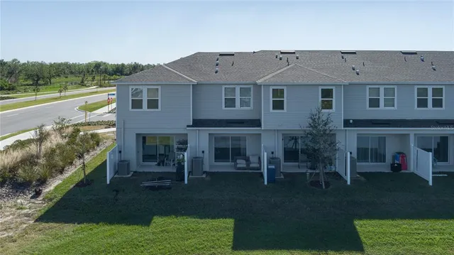 a view of house with yard and outdoor seating