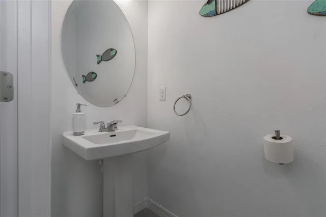 a bathroom with a sink a toilet and mirror