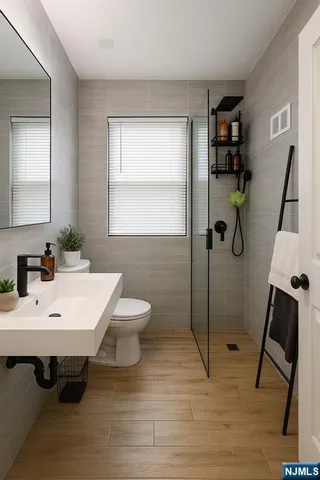 a bathroom with a sink toilet and shower